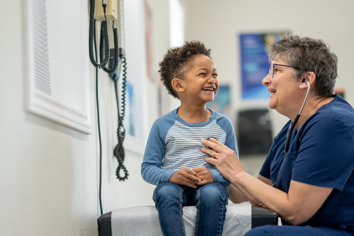 Health care worker talking to child